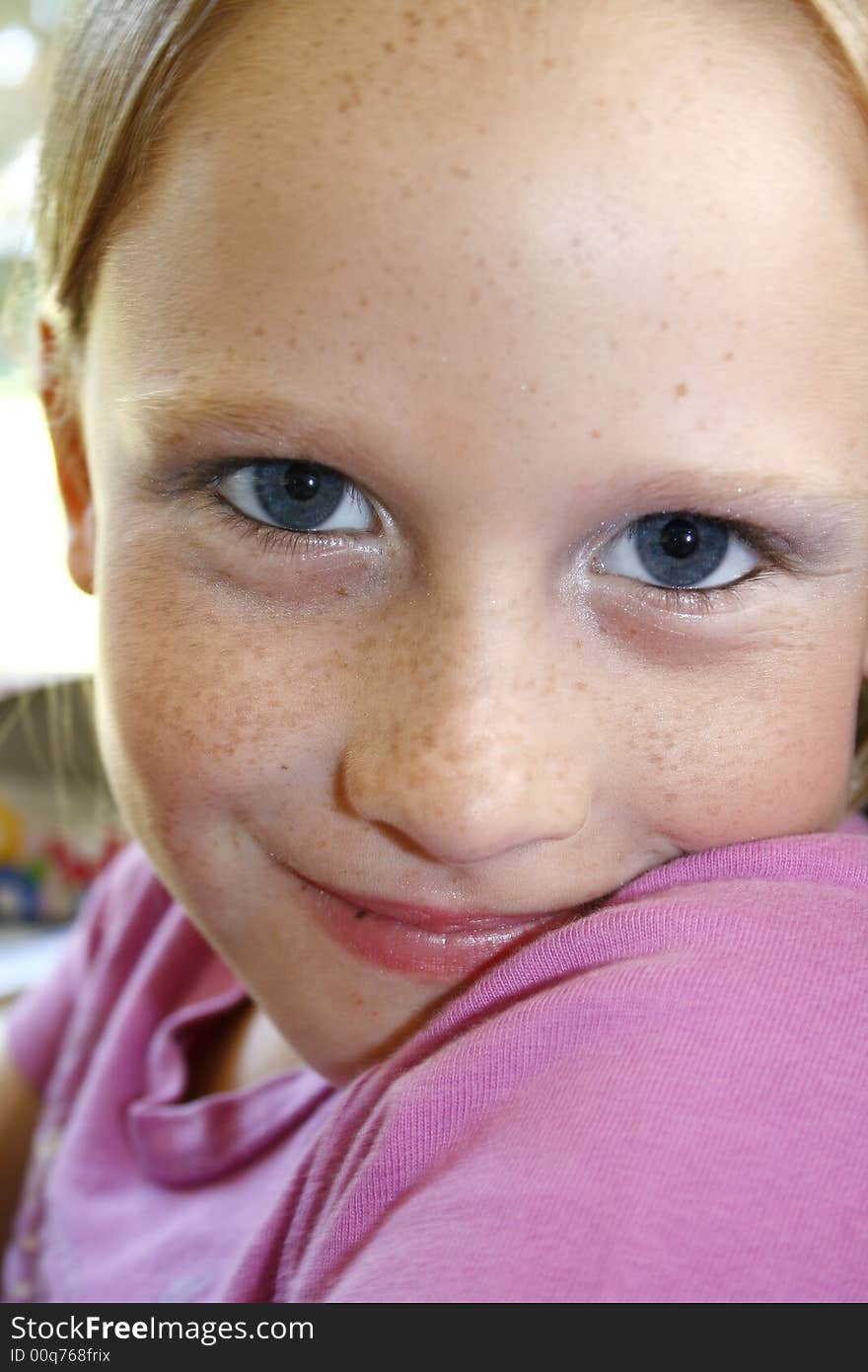 Young white caucasian girl sitting with a happy expression on her face. Young white caucasian girl sitting with a happy expression on her face