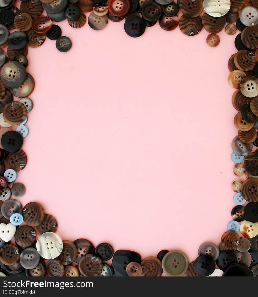 Many buttons on a pink background for scrapbooking. Many buttons on a pink background for scrapbooking