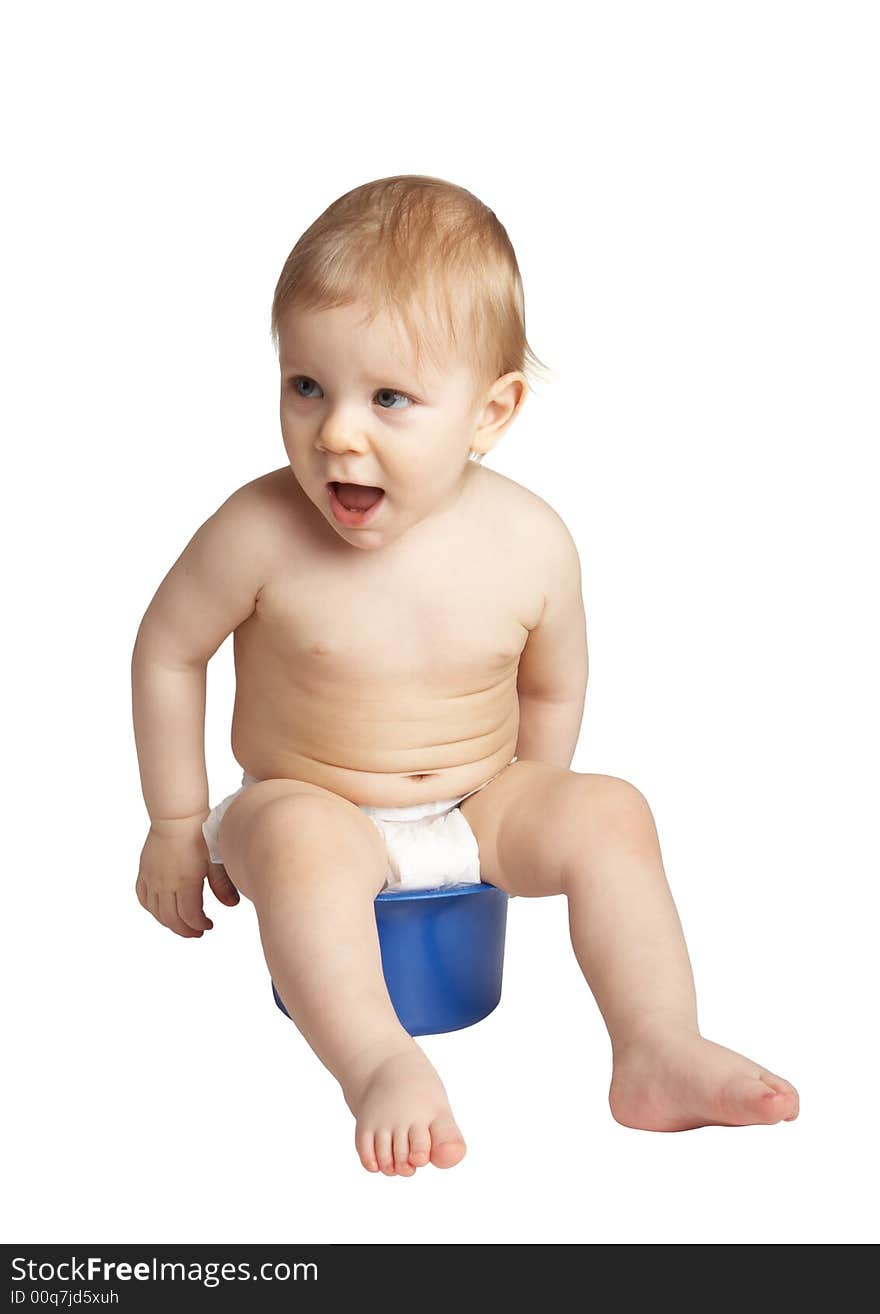 Baby sits on a pot. on white