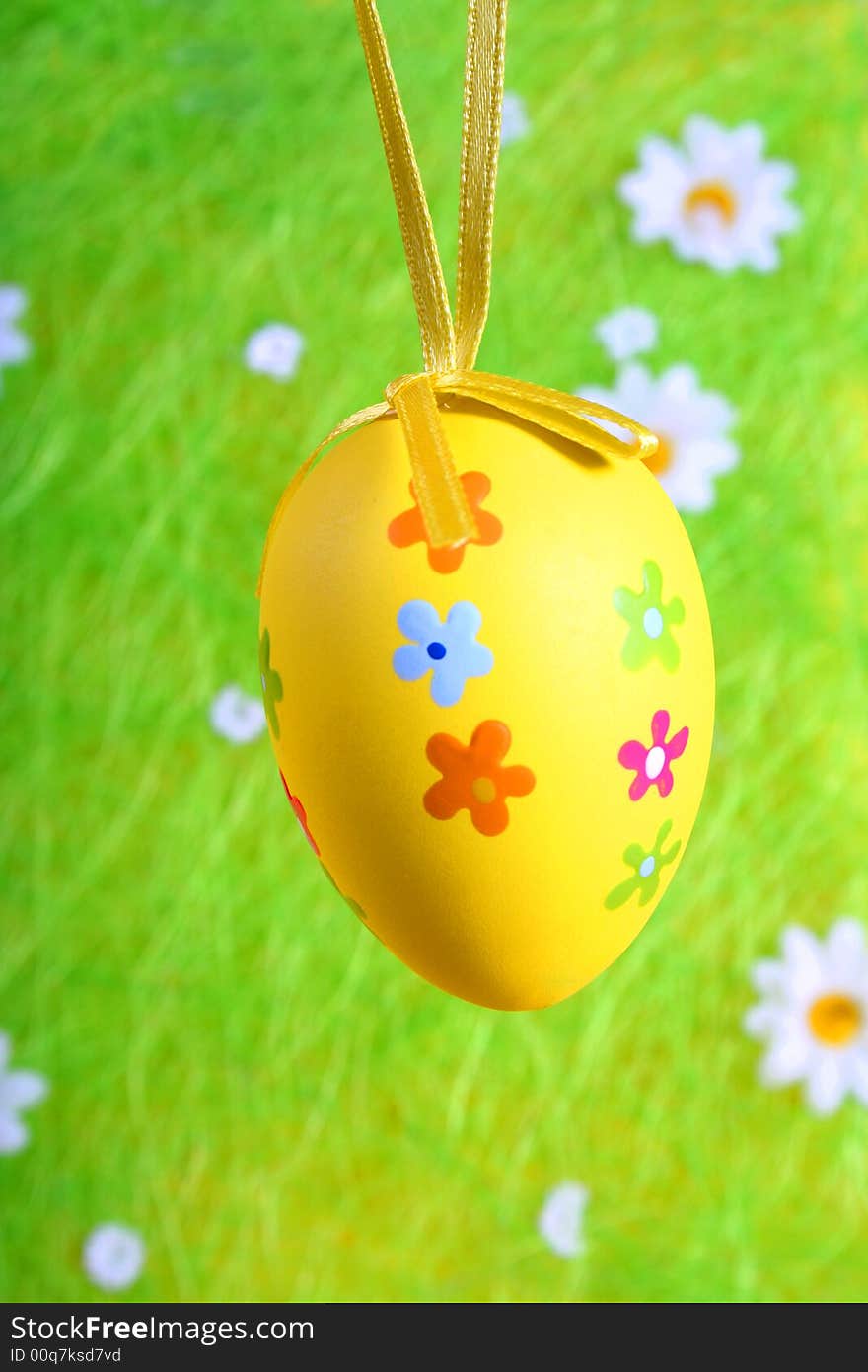 Pastel and colored Easter egg on green