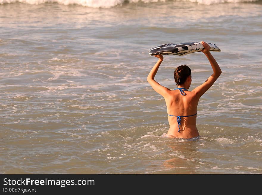 Bikini Girl with boogie board in the ocean. Bikini Girl with boogie board in the ocean