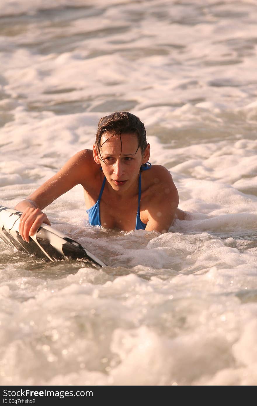 Bikini Girl with boogie board in the water. Bikini Girl with boogie board in the water