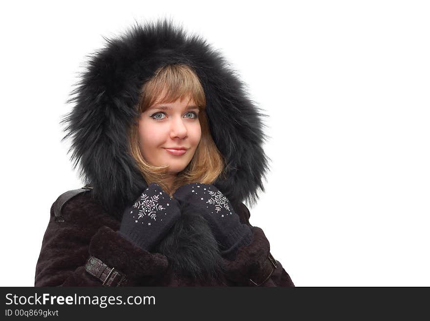 Beautiful girl in a fur coat with a hood isolated over a white background