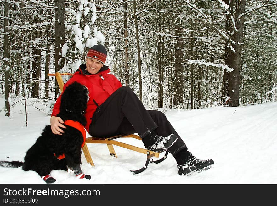 Kicksledding in an Ontario forest. Taking a break on the trail after a heavy snowfall. Kicksledding in an Ontario forest. Taking a break on the trail after a heavy snowfall.