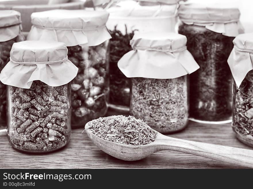 An image of herbal tea in a wooden spoon and glasses. An image of herbal tea in a wooden spoon and glasses