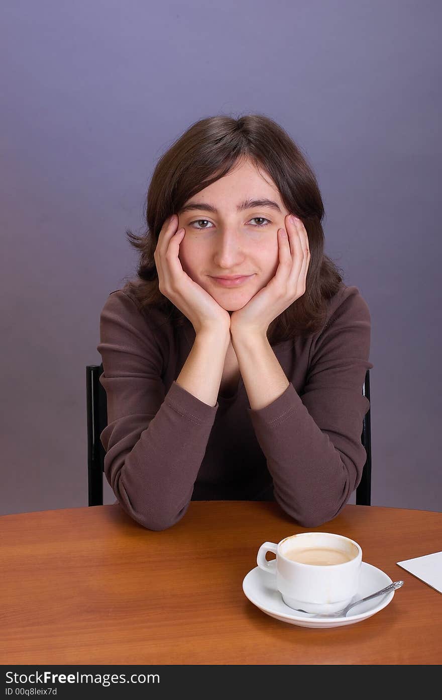 The beautiful girl with a coffee mug on a grey background. The beautiful girl with a coffee mug on a grey background