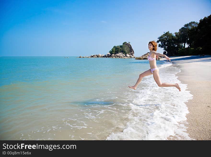 Young woman having fun by the sea