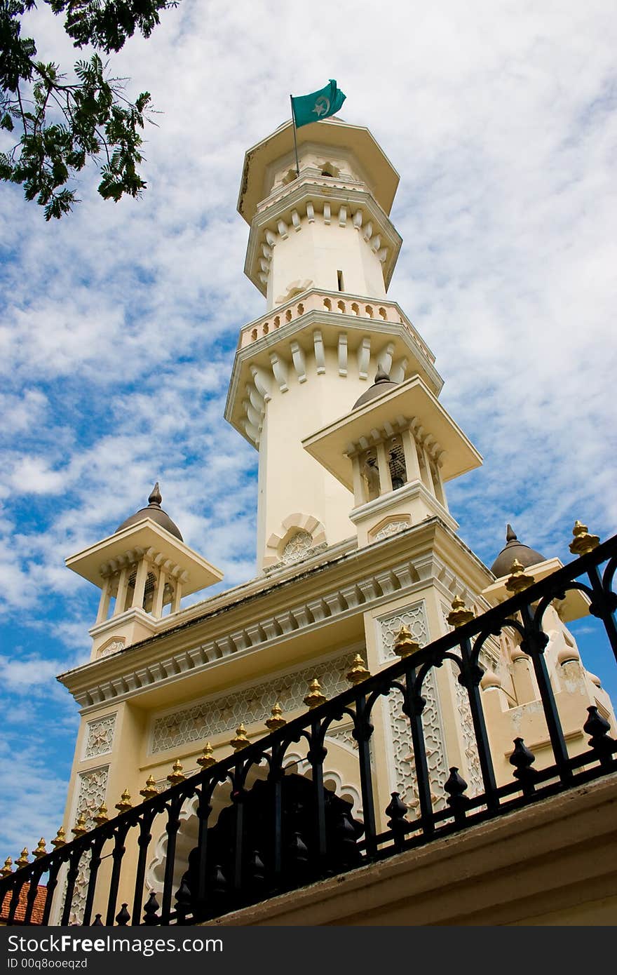 Impressive mosque tower architecture with blue sky white clouds. Impressive mosque tower architecture with blue sky white clouds