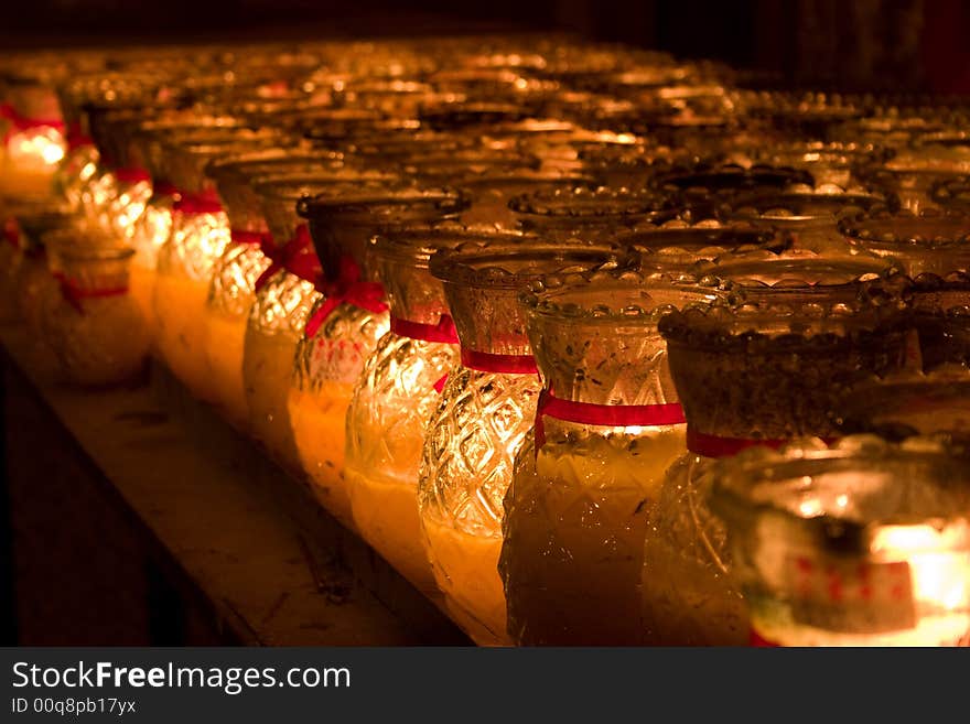 Rows Of Candles In Glass Lighted