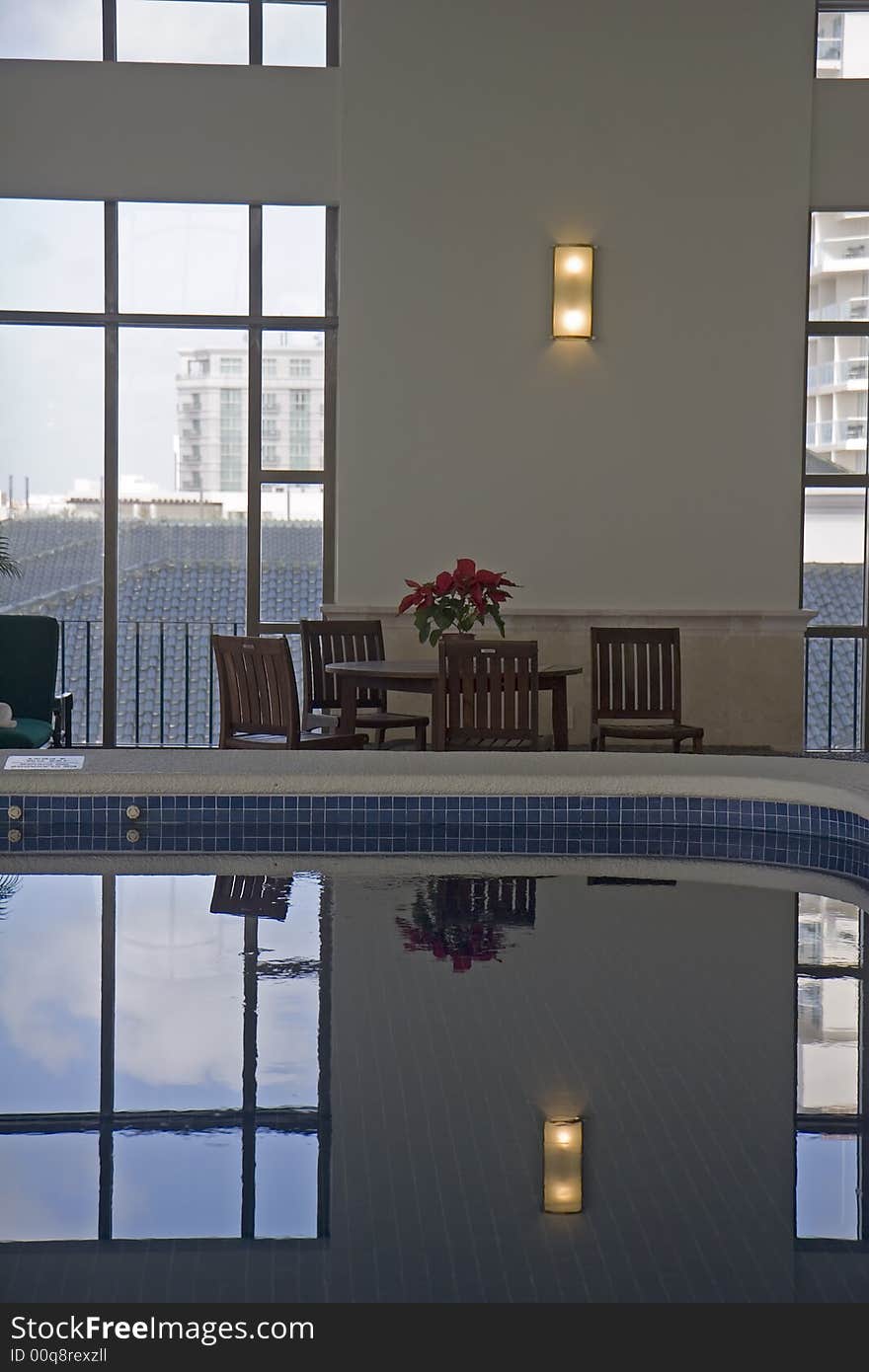 A nice indoor pool in a spa with a poinsettia on the table. A nice indoor pool in a spa with a poinsettia on the table