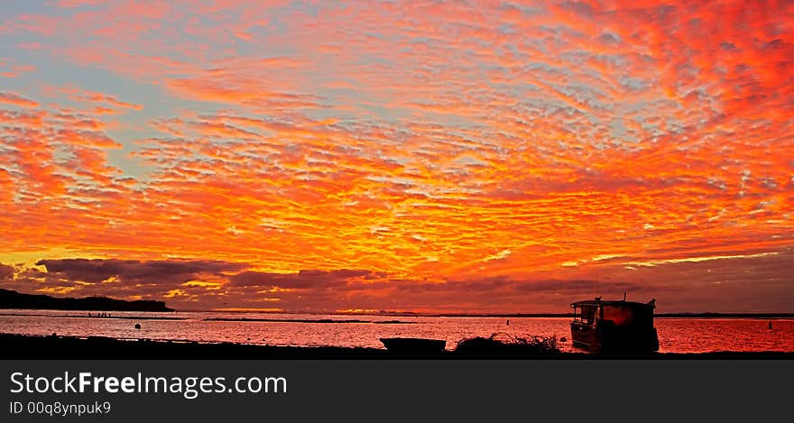 Lonely boat and tropical sunset