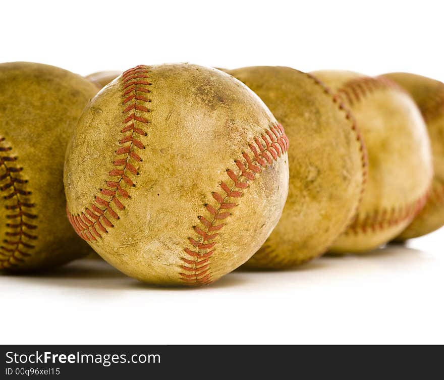 A background of vintage, antique, old baseballs on a white background with copy space. A background of vintage, antique, old baseballs on a white background with copy space