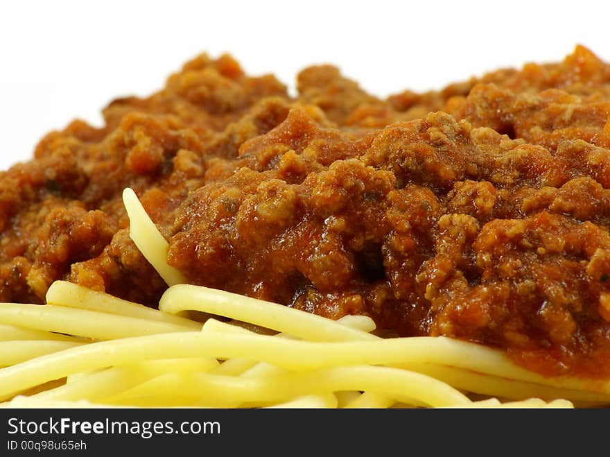 Fresh cooked white spaghetti pasta and juicy tomato meat sauce, often referred to as Italian Spaghetti, on white porcelain plate and white background. Close up macro. Fresh cooked white spaghetti pasta and juicy tomato meat sauce, often referred to as Italian Spaghetti, on white porcelain plate and white background. Close up macro.