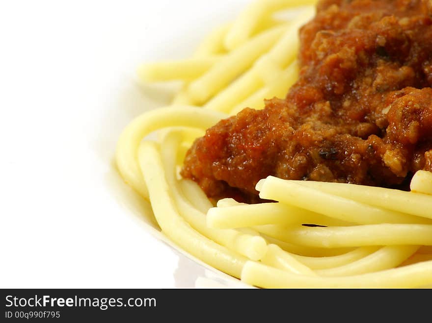 Fresh cooked white spaghetti pasta and juicy tomato meat sauce, often referred to as Italian Spaghetti, on white porcelain plate and white background. Close up macro. Fresh cooked white spaghetti pasta and juicy tomato meat sauce, often referred to as Italian Spaghetti, on white porcelain plate and white background. Close up macro.