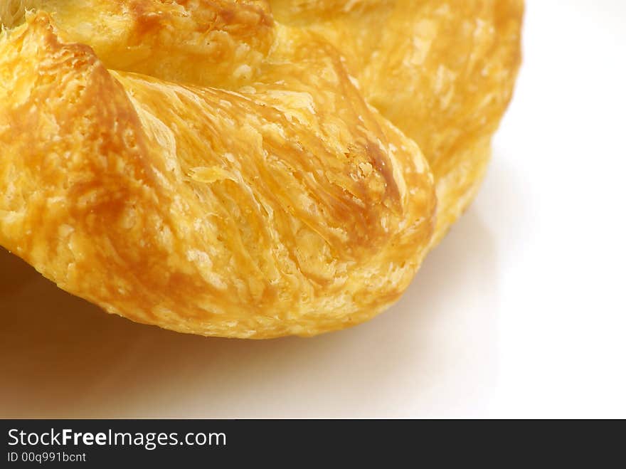 Extreme close up of Butter Croissant pastry on white background. Extreme close up of Butter Croissant pastry on white background.