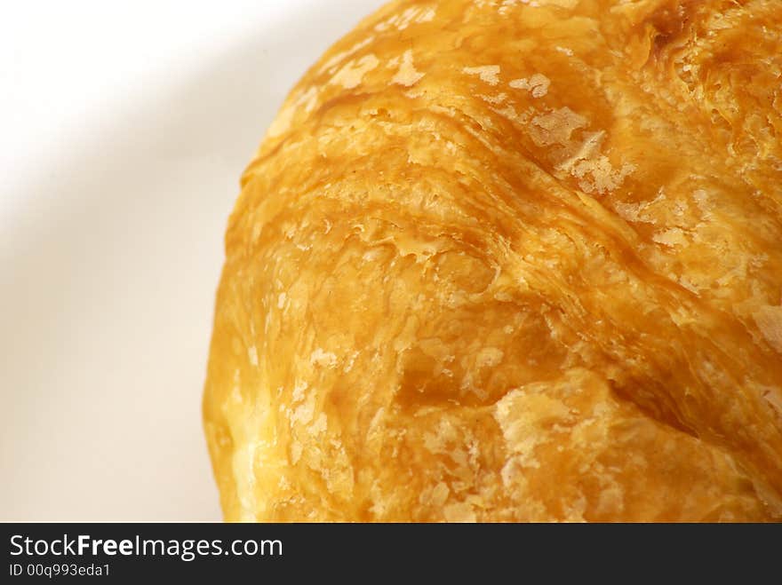 Extreme close up of Butter Croissant pastry on white background. Extreme close up of Butter Croissant pastry on white background.