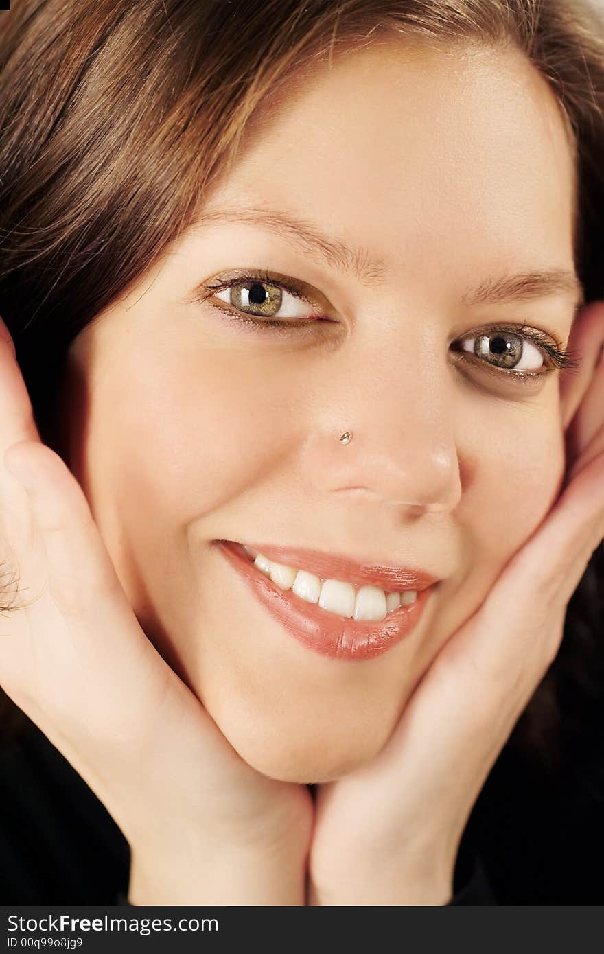 Happy young girl covering face with hands