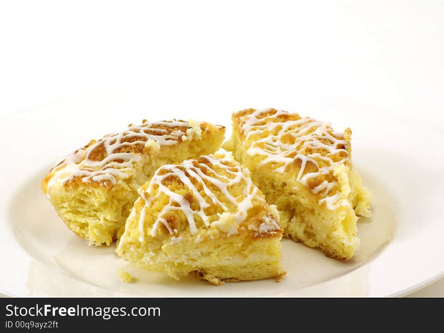 Fresh, moist pieces of streusel cheese coffee cake on white plate with white background. Fresh, moist pieces of streusel cheese coffee cake on white plate with white background.