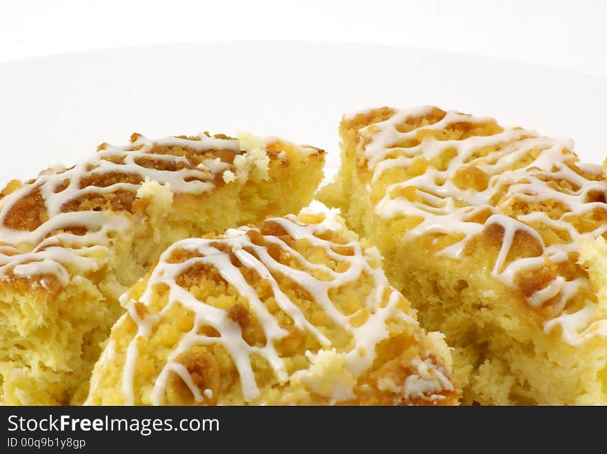 Fresh, moist pieces of streusel cheese coffee cake on white plate with white background. Fresh, moist pieces of streusel cheese coffee cake on white plate with white background.