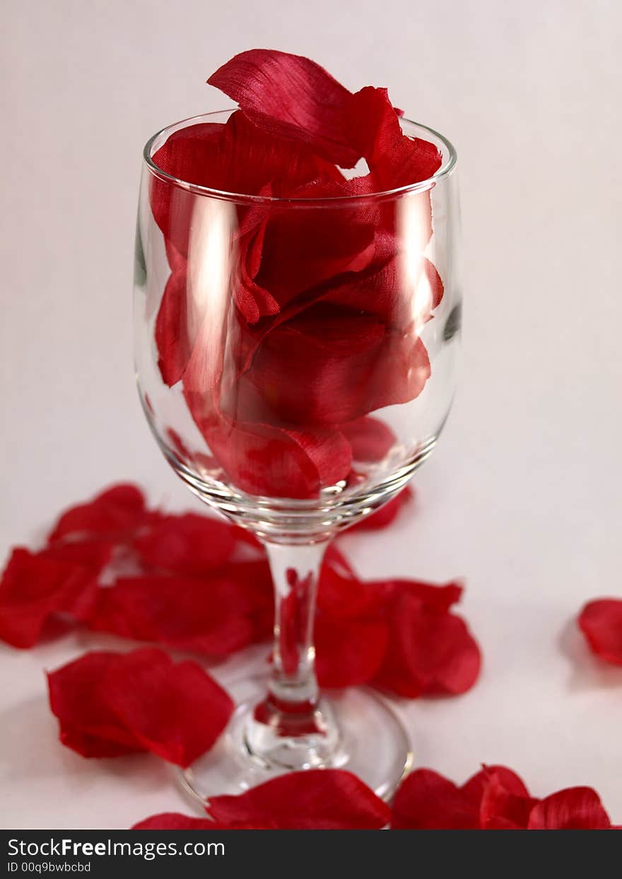 Wine glass with silk rose petals. Wine glass with silk rose petals.