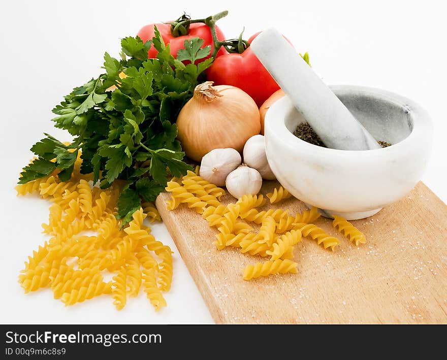 Tomatoes parsley garlic pasta spices and onion studio shot isolated. Tomatoes parsley garlic pasta spices and onion studio shot isolated