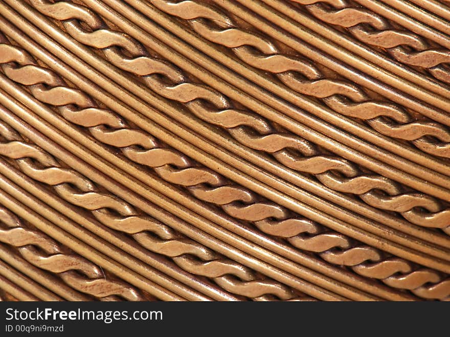 Close-up of a pattern on a golden bracelet