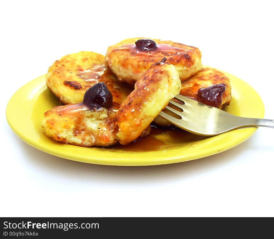 Sweet pancakes dessert with strawberry jam on the plate isolated