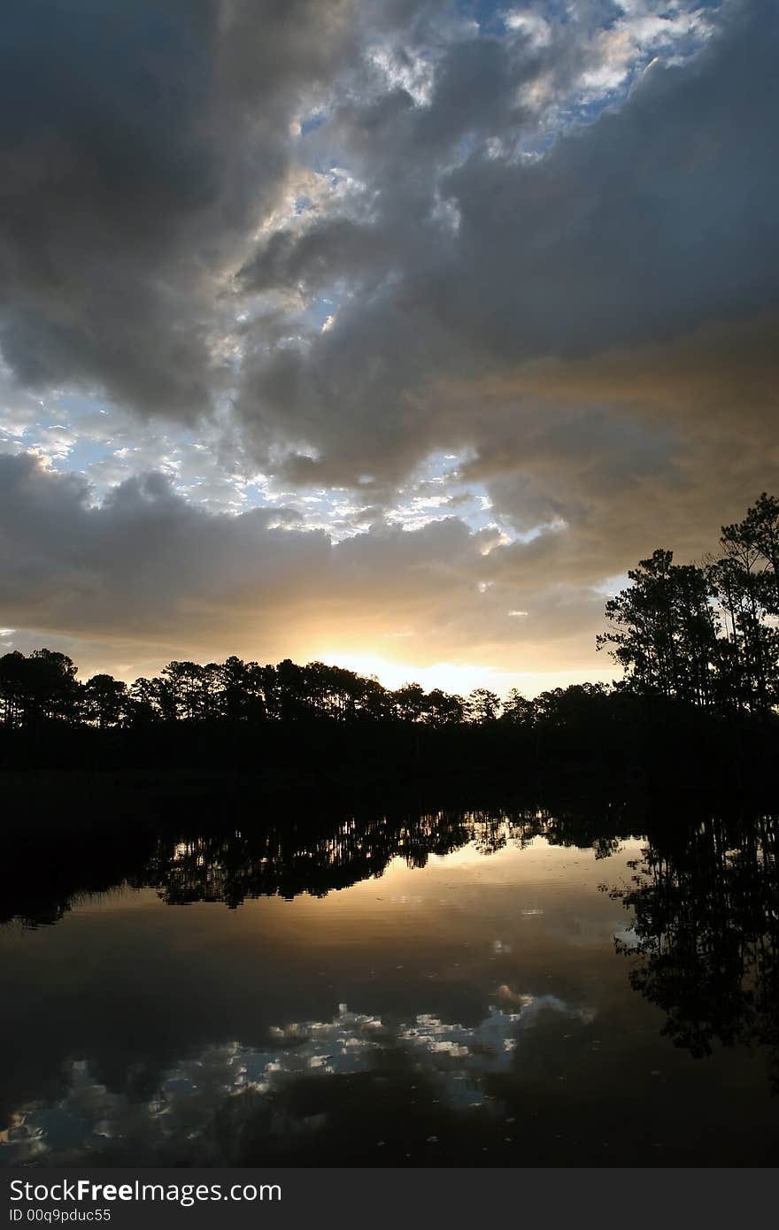 Scenic sunrise shot of the tree line in silhouette along the Neuse River in North Carolina. Scenic sunrise shot of the tree line in silhouette along the Neuse River in North Carolina.