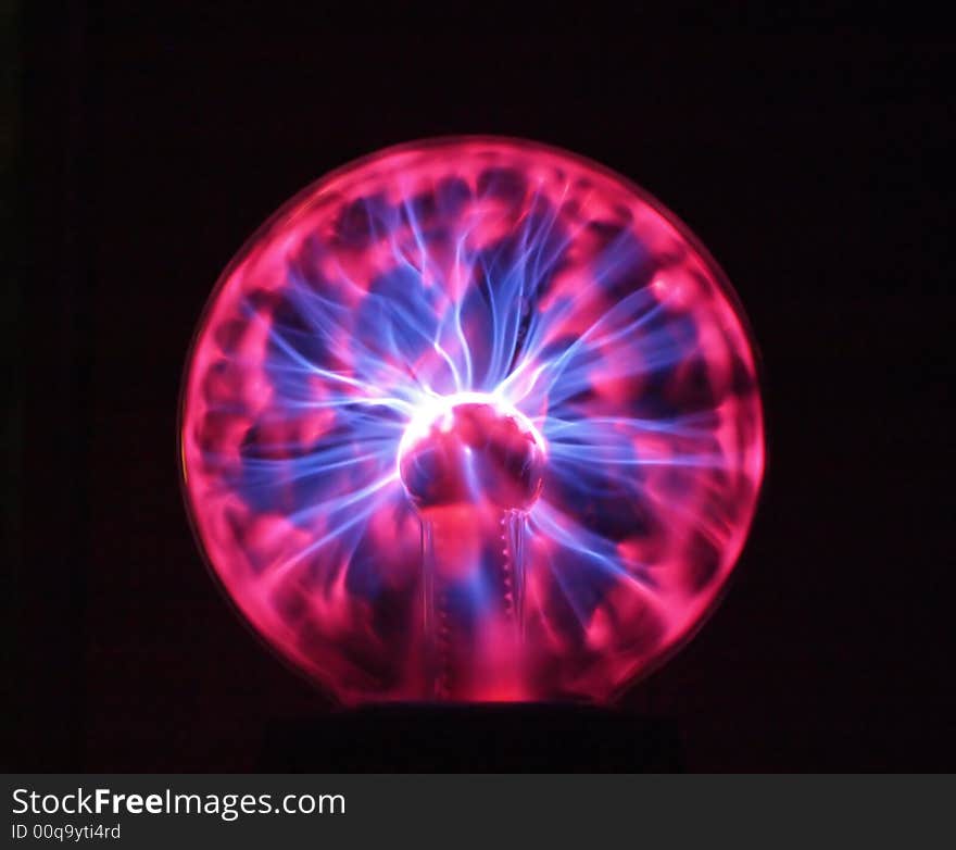 Electrical device sparking power plasma streams from center to the body of glass sphere. Electrical device sparking power plasma streams from center to the body of glass sphere