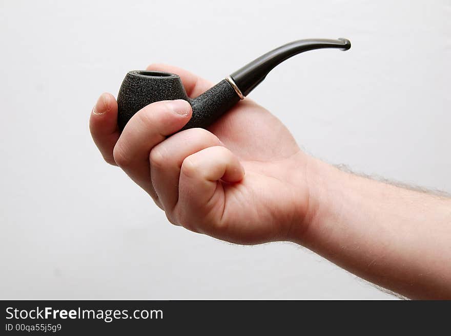 Hands holding tobacco-pipe isolated