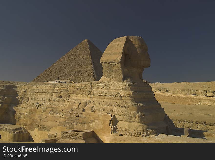 Sphinx with the great pyramid behind it Giza Cairo Egypt.