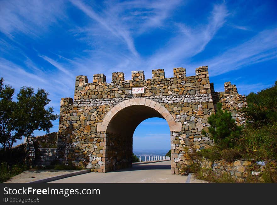 An ancient stone military gate built on a mountain. An ancient stone military gate built on a mountain