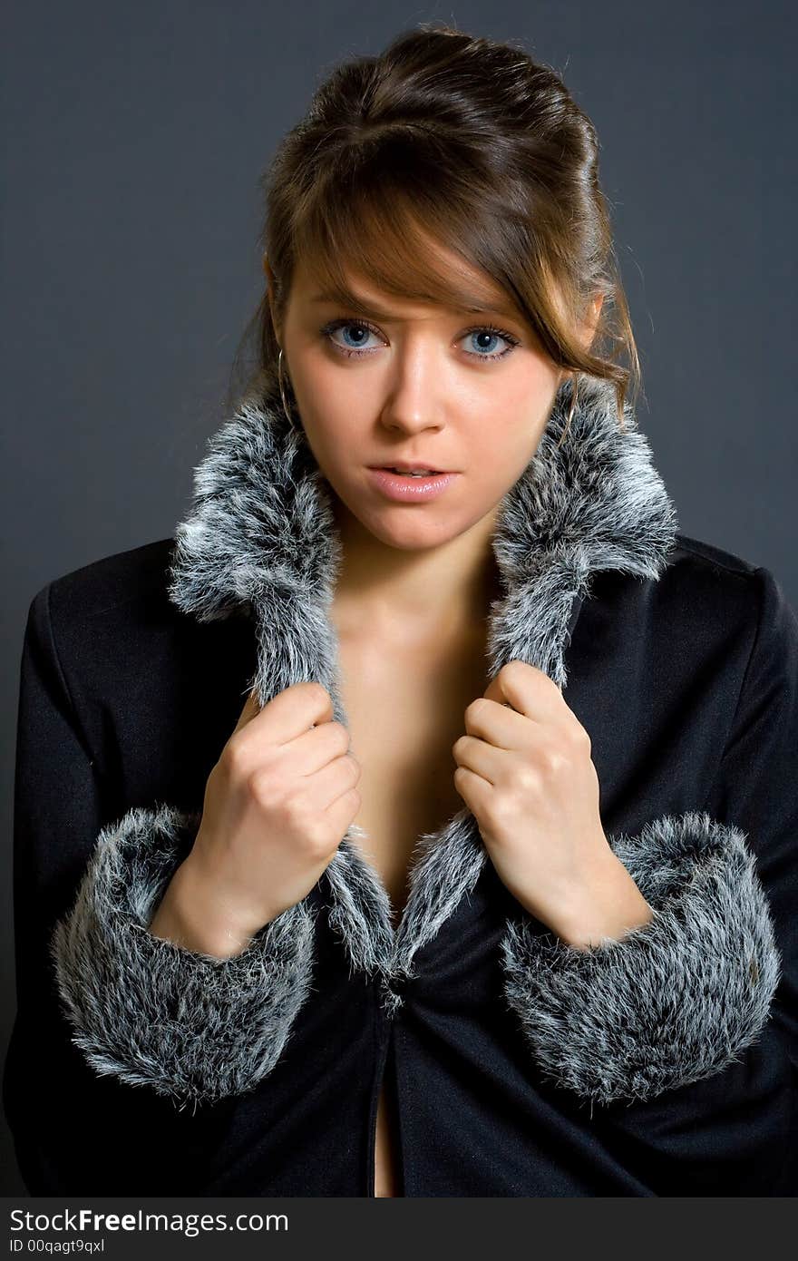 Woman in fur lined winter coat studio shot