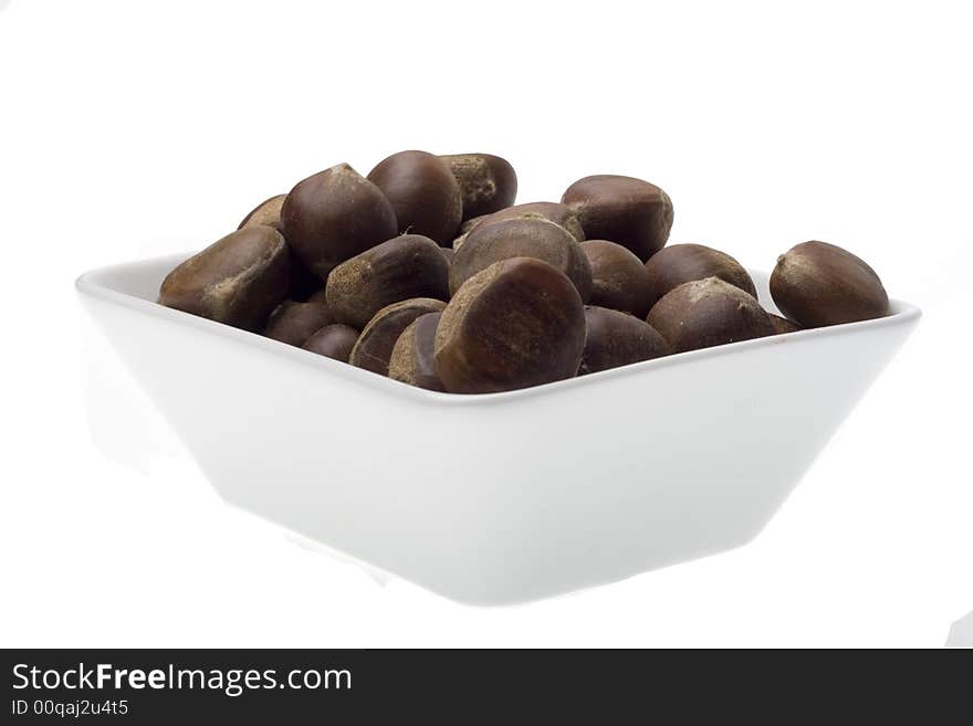 Chestnuts in the white bowl on white backgrounds