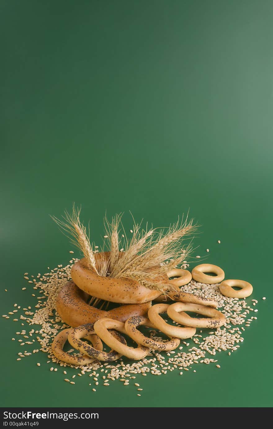 Group of some bagels and grains on a green background. Group of some bagels and grains on a green background.