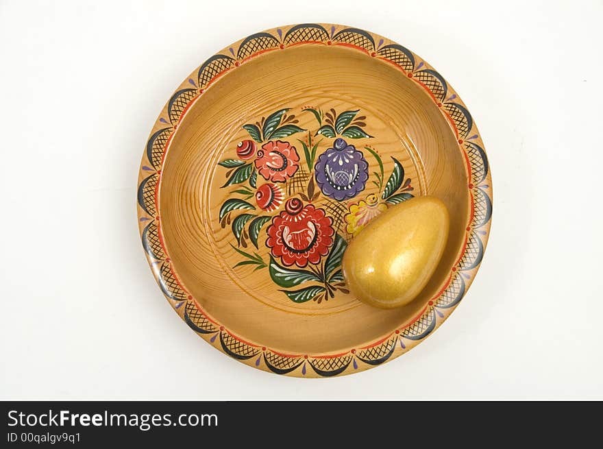 Colour wooden dish with figure and gold egg. Colour wooden dish with figure and gold egg.