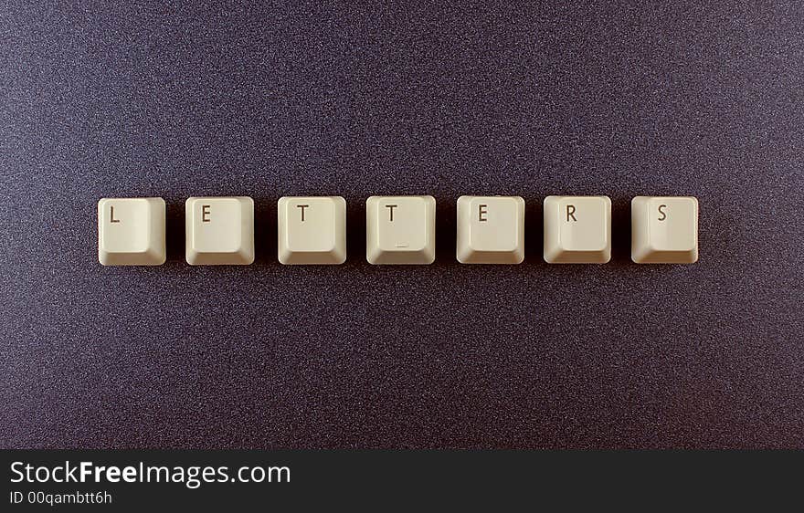 Computer keyboard letters on a dark background