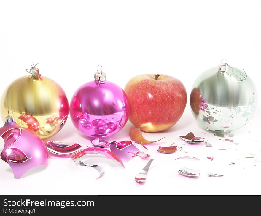 Christmas-tree decorations and apple on white  background