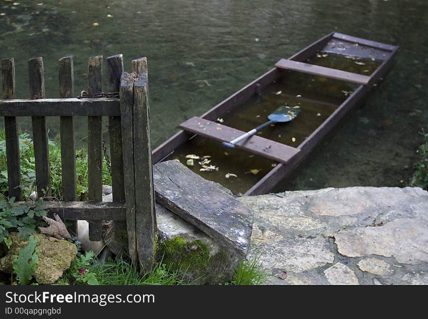 Fence and boat on quiet river. Fence and boat on quiet river