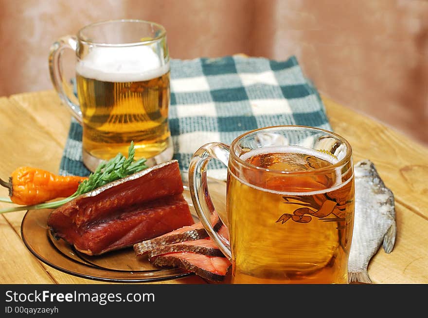 Mugs with beer and dried fishes. Mugs with beer and dried fishes