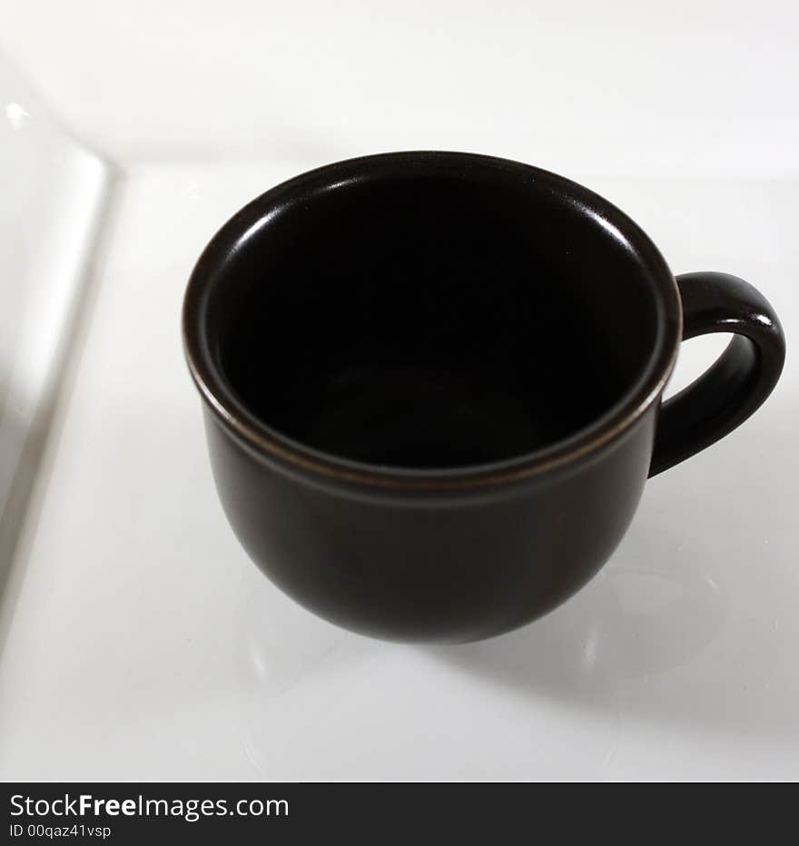 Brown cup on a white plate