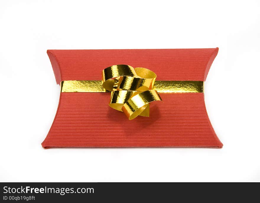 Red gift box with gold ribbon on white background