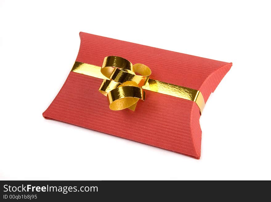 Red gift box with gold ribbon on white background