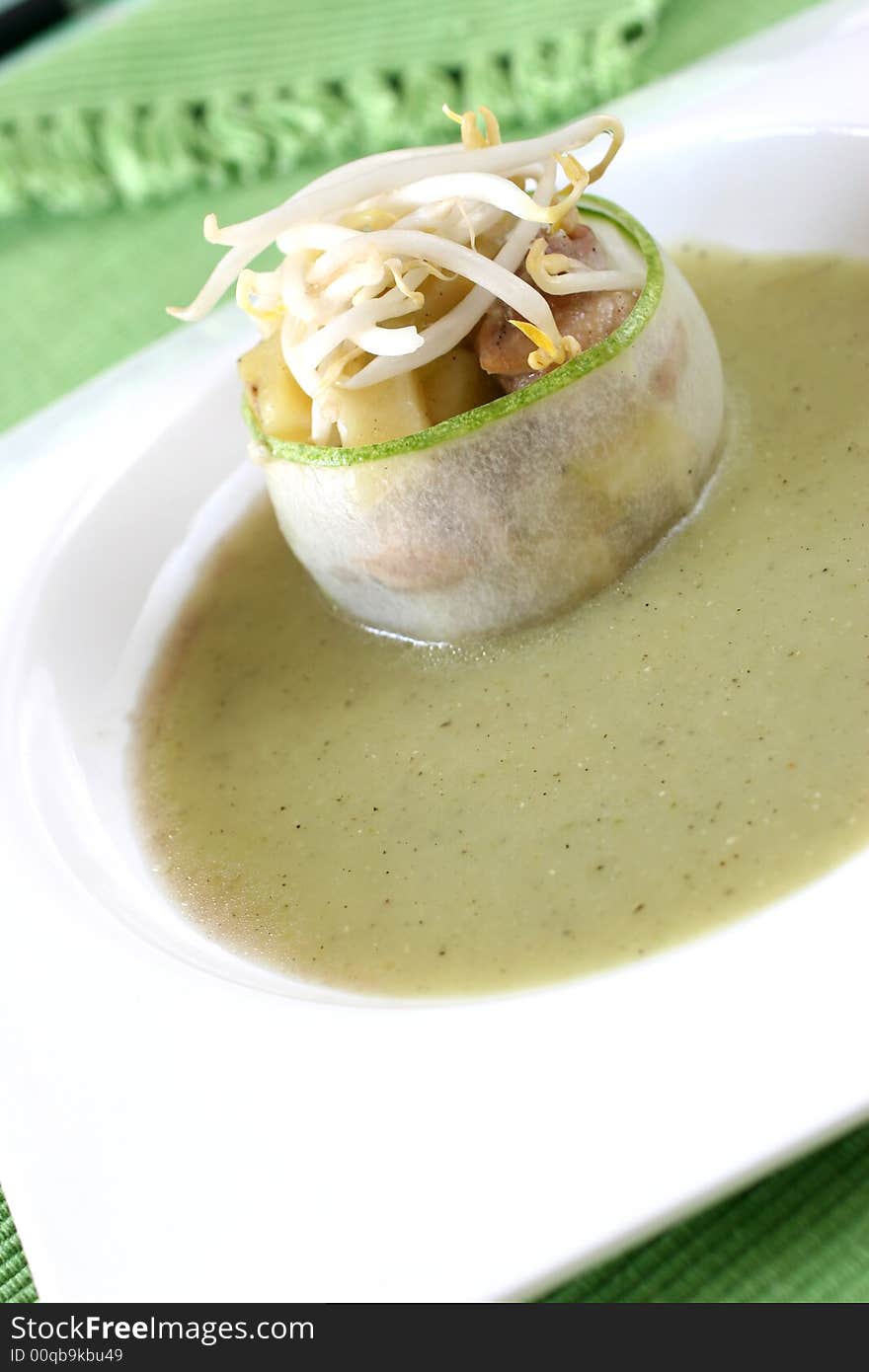 Cucumber wrapped chicken and potato chunks, topped with mung bean sprouts in cucumber sauce. Cucumber wrapped chicken and potato chunks, topped with mung bean sprouts in cucumber sauce