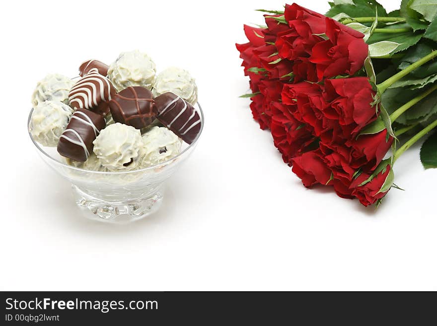 Mixed delicious chocolates
and red rose on white background. Mixed delicious chocolates
and red rose on white background.