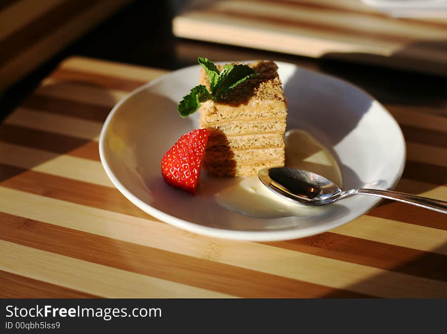 Slice of a pie and strawberry on a plate