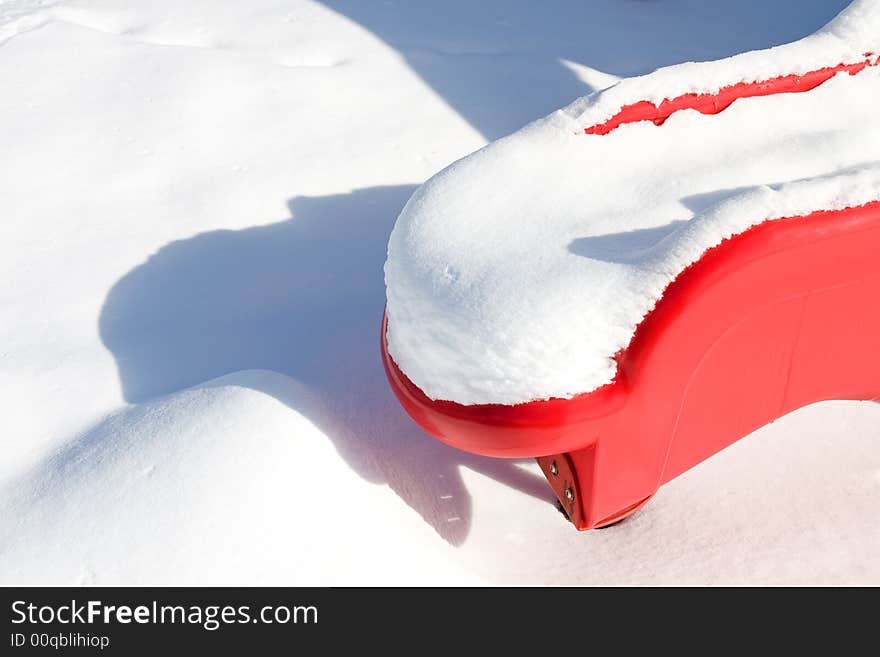 Red Plastic Slide in Snow