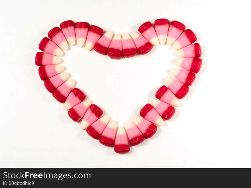 Candy Corns shaped in to a heart on a white background. Candy Corns shaped in to a heart on a white background.