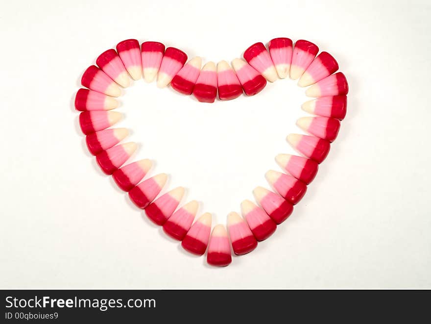 Candy Corns shaped in to a heart on a white background. Candy Corns shaped in to a heart on a white background.