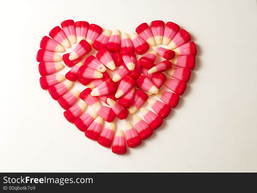 Candy Corns shaped in to a heart on a white background. Candy Corns shaped in to a heart on a white background.